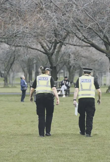  ??  ?? 2 Police on patrol in Edinburgh’s Meadows during the lockdown