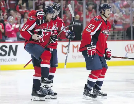  ?? ROB CARR/GETTY IMAGES ?? Justin Williams of the Washington Capitals celebrates with John Carlson and Jay Beagle after scoring the game-winning goal in overtime to defeat the Toronto Maple Leafs 2-1 in Game 5 of the Eastern Conference First Round at Verizon Center Friday in...