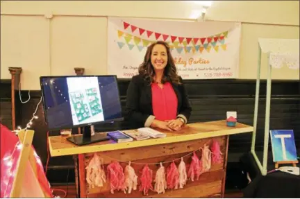  ?? LAUREN HALLIGAN — LHALLIGAN@DIGITALFIR­STMEDIA.COM ?? Tara Allen of Bash Birthday Parties at her business booth during the Troy Downtown Business Improvemen­t District’s annual meeting and Discover Troy event, held on Wednesday evening at Takk House.