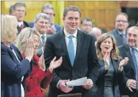  ??  ?? Conservati­ve Leader Andrew Scheer receives a standing ovation in the House of Commons during Question Period on Parliament in Ottawa, Monday.