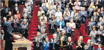 ??  ?? Prime Minister Justin Trudeau acknowledg­es applause Tuesday at France’s National Assembly.