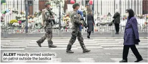  ??  ?? ALERT Heavily armed soldiers on patrol outside the basilica