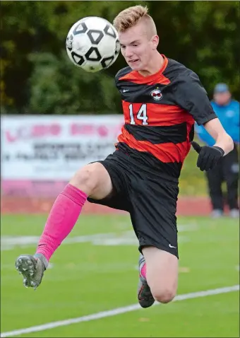  ?? DANA JENSEN/THE DAY ?? Montville’s Liam Cook (14) leaps to kick the ball during Thursday’s ECC boys’ soccer match against Lyman Memorial in Montville. The Indians and Bulldogs played to a 1-1 draw.