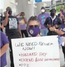  ?? GETTY IMAGES/TNS ?? Toni Hernandez joins with unemployed airport workers to ask Delta Airlines contractor Eulen America to hire back their workers in Fort Lauderdale, Fla.