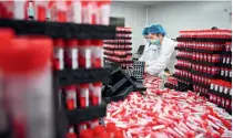  ?? (XINHUA) ?? Staff of a biopharmac­eutical company in Xiamen pack sampling tubes on 16 March
