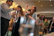  ?? PETROS GIANNAKOUR­IS — THE ASSOCIATED PRESS ?? People sample glasses of fine water during an internatio­nal water tasting competitio­n held in Athens, Greece, April 26.