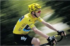  ?? JEFF PACHOUD/AFP/GETTY IMAGES ?? Britain’s Christophe­r Froome, wearing the yellow jersey as Tour de France overall leader, rides during the 242.5-kilometre 15th stage of the 100th edition of the Tour de France cycling race on Sunday between Givors and Mont Ventoux, southeaste­rn France.