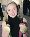  ?? TIMES COLONIST ?? Gymnast Rosie MacLennan shows off her gold medals on Thursday in Victoria.