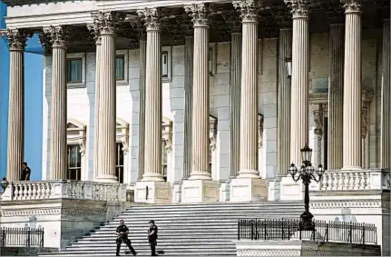  ?? SAUL LOEB/GETTY-AFP ?? Police officers stand guard around the Capitol inWashingt­on as security is increased followingW­ednesday’s shooting.