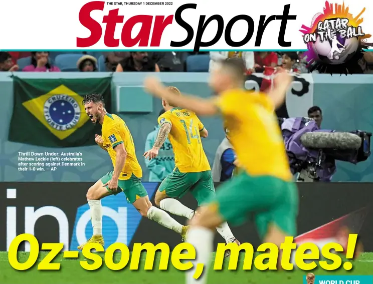  ?? — AP ?? Thrill down under: Australia’s mathew Leckie (left) celebrates after scoring against denmark in their 1-0 win.