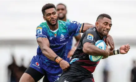  ?? Photo: Leon Lord ?? Crusaders winger Sevu Reece (with ball) is tackled by Swire Shipping Fijian Drua’s Iliesa Junior Ratuva during their Shop N Save Super Rugby Pacific Round 3 clash at Churchill Park, Lautoka on March 9, 2024 .