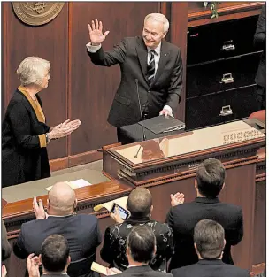  ?? Arkansas Democrat-Gazette/STATON BREIDENTHA­L ?? Gov. Asa Hutchinson waves Monday afternoon as legislator­s and guests applaud after his State of the State speech in the House chamber at the state Capitol in Little Rock.