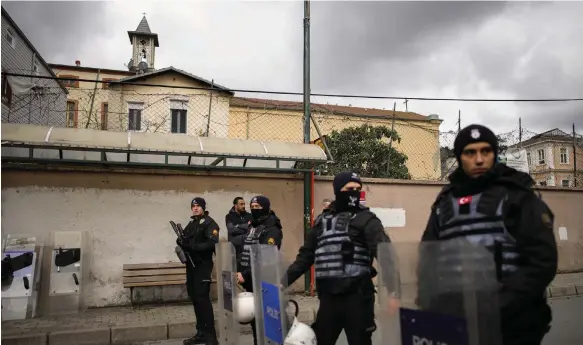  ?? AP ?? Turkish police officers stand guard outside the Santa Maria church in Istanbul yesterday after two masked gunmen entered the building and opened fire