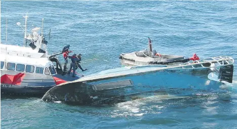  ?? COREY MELCHIOR ?? The coast guard dive team works in 2002 at the site of the capsized fishing vessel Cap Rouge II. Five people died in the accident.