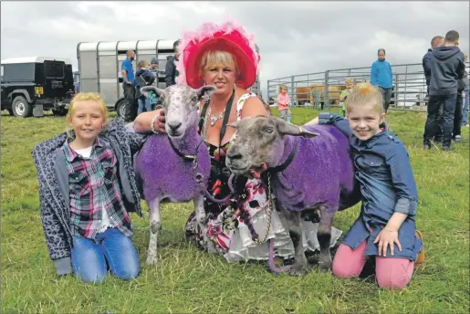  ??  ?? Mairi Porter, centre, painted her two sheep purple ‘for the craic’, with Bowmore Primary pupils, left, Amy Stewart, nine, and Josie Rountree, eight. 16_T33_ Islay Show_ 21