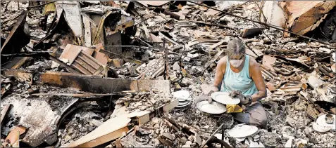  ?? GARY CORONADO/LOS ANGELES TIMES ?? Maureen Kissick looks over some china after a wildfire destroyed her home in Redding, Calif., this month.