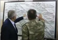  ?? PRIME MINISTRY PRESS SERVICE PHOTO VIA AP, FILE ?? In this Monday file photo, an army commander informs Turkey’s Prime Minister Binali Yildirim, left, on a TurkeyIraq border map, in Cukurca, Turkey. Just days into the operation to retake the Islamic State-held city of Mosul, a fault-line has widened...