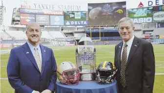  ?? AP PHOTO ?? BATTLE IN THE BRONX: Boston College football coach Steve Addazio (left) and Iowa counterpar­t Kirk Ferentz pose yesterday at Yankee Stadium, where their teams will square off in the Pinstripe Bowl on Dec. 27.