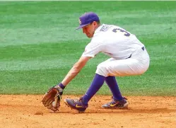  ?? Butch Dill/Associated Press ?? ■ LSU shortstop Hal Hughes fields a ground ball before throwing out Mississipp­i's Cole Zabowski at first during the third inning of the Southeaste­rn Conference tournament NCAA baseball championsh­ip game Sunday in Hoover, Ala.