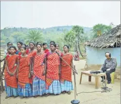  ?? GAYATRI JAYARAMAN/HT PHOTO ?? ■ All India Radio executives record (left) a flute recital and (top) folk song at a Santhali village. Equipped with rudimentar­y devices and a desire to preserve heritage, they trek to villages where roads haven’t been laid yet.
