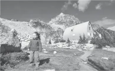  ?? Matt Gunn/for the Calgary Herald ?? Young Kate Kucharski is seen wandering in Invermere in the Columbia Valley. Invermere and its neighbouri­ng communitie­s have long been treated as the backyard playground for Calgarians, who own trailers and condos in the region.