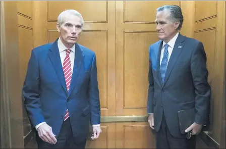  ?? JOSE LUIS MAGANA — THE ASSOCIATED PRESS FILE ?? Sen. Rob Portman, R-Ohio, left, accompanie­d by Sen. Mitt Romney, R-Utah, leave in the elevator after closed door talks about infrastruc­ture July 15 on Capitol Hill in Washington.