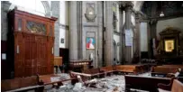  ?? THE ASSOCIATED PRESS ?? Debris from the cupola of Our Lady of Angels Church is scattered on the pews and floor below a framed image of Pope John Paul II on Sunday in Mexico City.