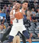  ??  ?? Grizzlies guard Jevon Carter (3) goes to the basket against the Spurs. RICK BOWMER/AP