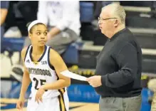  ?? STAFF FILE PHOTO BY ROBIN RUDD ?? UTC guard Chelsey Shumpert awaits instructio­ns from coach Jim Foster during a home game against Samford last month. The Mocs will learn their seed and first-round destinatio­n for the NCAA tournament tonight.