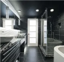  ??  ?? Zebra-striped black granite provides contrast in this bathroom.