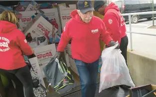  ?? HARRY FISHER/THE MORNING CALL ?? Longtime Toys for Tots Allentown volunteer Marty Hacker in 2018 helps unload a truck filled with collection­s of donated toys.