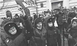  ?? AP ?? People gather Tuesday in front of the Supreme Court of the Russian Federation in Moscow, after Russia’s Supreme Court ruled that one of the country’s oldest and most prominent human rights organizati­ons should be shut down.