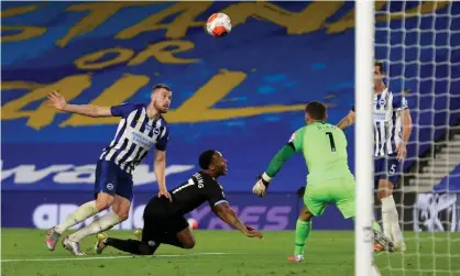  ?? Photograph: Manchester City FC/Getty Images ?? A falling Raheem Sterling watches the ball drop, allowing him to head an unconventi­onal hat-trick goal, Manchester City’s fifth at Brighton.