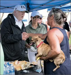  ?? The New York Times/ DOUG MILLS ?? President Donald Trump and his wife, Melania ( center), serve sandwiches to people affected by Hurricane Irma on Thursday in Naples, Fla. “We are there for you 100 percent,” Trump said.