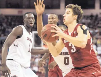  ?? SEAN RAYFORD/ASSOCIATED PRESS ?? Arkansas guard Dusty Hannahs (3) drives to the basket against South Carolina’s Sindarious Thornwell (0) during Wednesday’s game. Hannahs scored 20 points as the Razorbacks earned an 83-76 victory.
