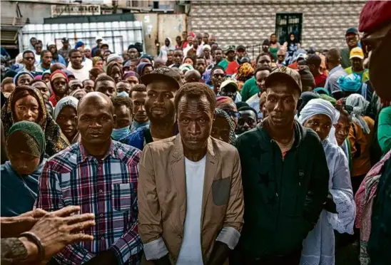  ?? JOHN WESSELS/AFP VIA GETTY IMAGES ?? Voters waited outside a voting station at the Foyer des Jeunes in Grand Yoff in Dakar on Sunday.