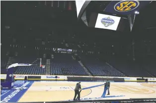  ?? CHRISTOPHE­R HANEWINCKE­L/USA TODAY SPORTS ?? Workers at Bridgeston­e Arena in Nashville remove signage and seating following the cancellati­on of the SEC men’s basketball tournament due to the novel coronaviru­s pandemic.