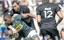  ?? Picture: LUCAS BARIOULET / AFP ?? GETTING A TIGHT GRIP: SA’s Siviwe Soyizwapi is tackled by New Zealand's Tim Mikkelson during the HSBC Paris Sevens Series rugby semifinal between the two nations at the Stade Jean Bouin in the French capital on Sunday.