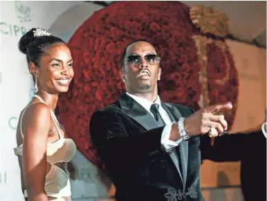  ?? KATHY WILLENS/AP ?? Sean “Diddy” Combs with Kim Porter, at his birthday celebratio­n on Nov. 4, 2004.