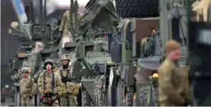  ?? The Associated Press ?? ■ Soldiers of the 2nd Cavalry Regiment line up vehicles at the military airfield in Vilseck, Germany, Wednesday as they prepare for the regiment’s movement to Romania to support NATO allies and demonstrat­e U.S. commitment to NATO Article V.