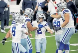  ?? Michael Ainsworth, The Associated Press ?? Cowboys teammates celebrate with Greg Zuerlein ( 2) after he kicked the game- winning field goal Sunday.