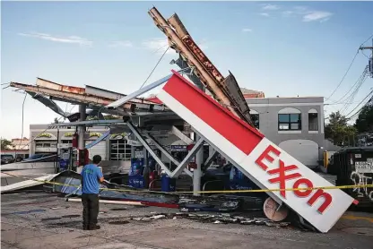  ?? New York Times file photo ?? A New York gas station lies damaged on Sept. 2 in the wake of Hurricane Ida, the latest part of a year of climate disasters.