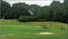  ??  ?? A group drives away from a green at the Frear Park Golf Course in Troy as they play a round Friday morning.