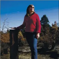  ?? PHOTOS BY JANE TYSKA — STAFF PHOTOGRAPH­ER ?? Co-owner Louise Moran stands by burned trees at the Crest Ranch Christmas Tree Farm in Santa Cruz on Dec. 9. The farm has been owned by her family for more than 40years and is recovering after the CZU Lightning Complex fire tore through the area in late August.