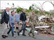  ?? EVAN VUCCI/AP PHOTO ?? President Donald Trump takes a walking tour to survey hurricane damage and recovery efforts in a neighborho­od in Guaynabo, Puerto Rico, on Tuesday.