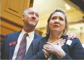  ?? ASSOCIATED PRESS FILE PHOTO ?? Janea Cox, right, whose daughter Haleigh suffers seizures, watches with Rep. Allen Peake, R-Macon, as the Georgia House approves “Haleigh’s Hope Act,” a bill legalizing possession of cannabis oil for treatment of certain medical conditions on March 25,...