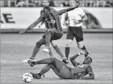  ?? CP PHOTO ?? Montreal Impact midfielder Tabla (13) jumps over a sliding tackle from Toronto FC defender Chris Mavinga (23) during second-half MLS soccer action in Toronto in this Oct.15, 2017, file photo.