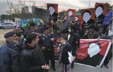  ?? B.K. Bangash / Associated Press ?? A human rights activists talks to police at a rally against missing people in Islamabad. The missing include journalist­s.