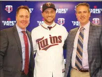  ?? Brace Hemmelgarn photo courtesy Minnesota Twins ?? Rocco Baldelli, center, smiles during a press conference Thursday introducin­g him as the new manager of the Minnesota Twins. With him are, at left, Twins Chief Baseball Officer Derek Falvey and at right, General Manager Thad Levine.