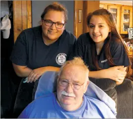  ?? STAFF PHOTO BY JOHN WHARTON ?? Brenda Renninger, left, a skipper with an area Sea Scout program, stands with Gabi Backus behind Douglas E. Yeckley, a Lusby resident who once served as commodore for the program’s regional council.